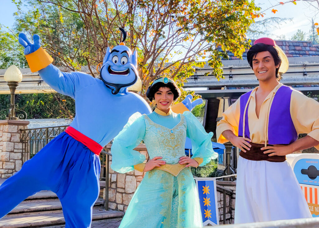 Disney's Genie, Jasmine and Aladin Characters standing together in Disneyland. 